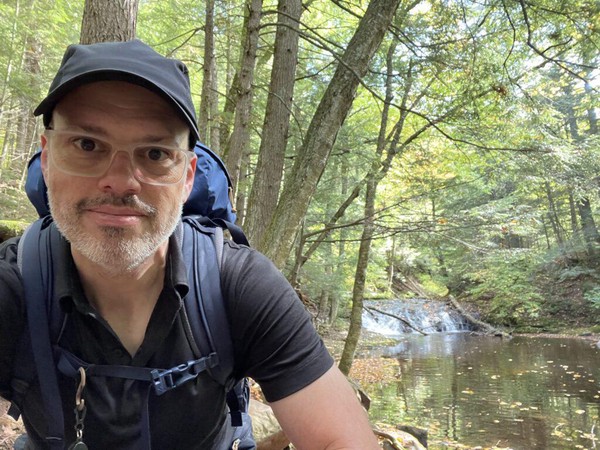 A small waterfall on Little Carp River in the background, me in the foreground