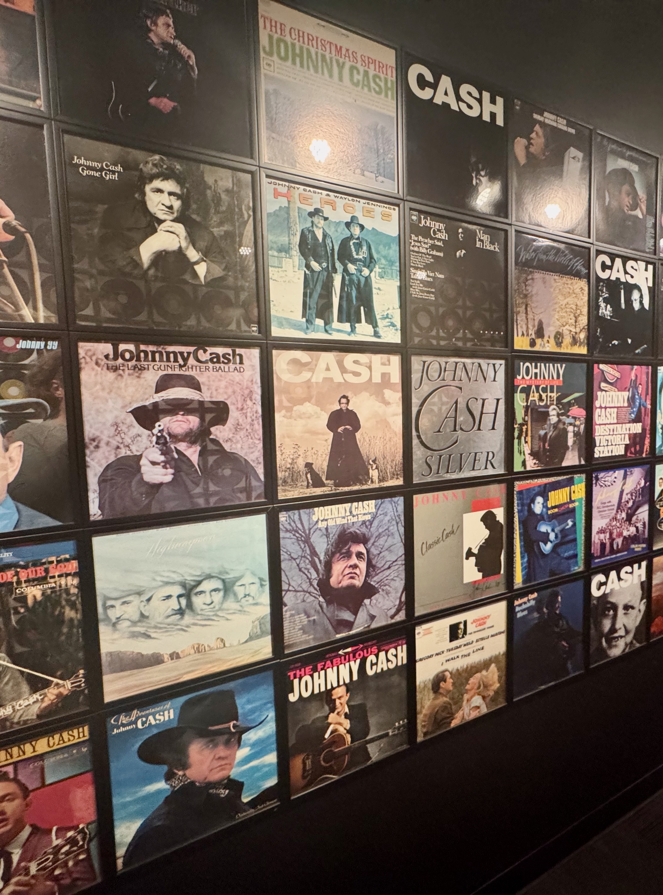 A wall tiled with Johnny Cash album covers