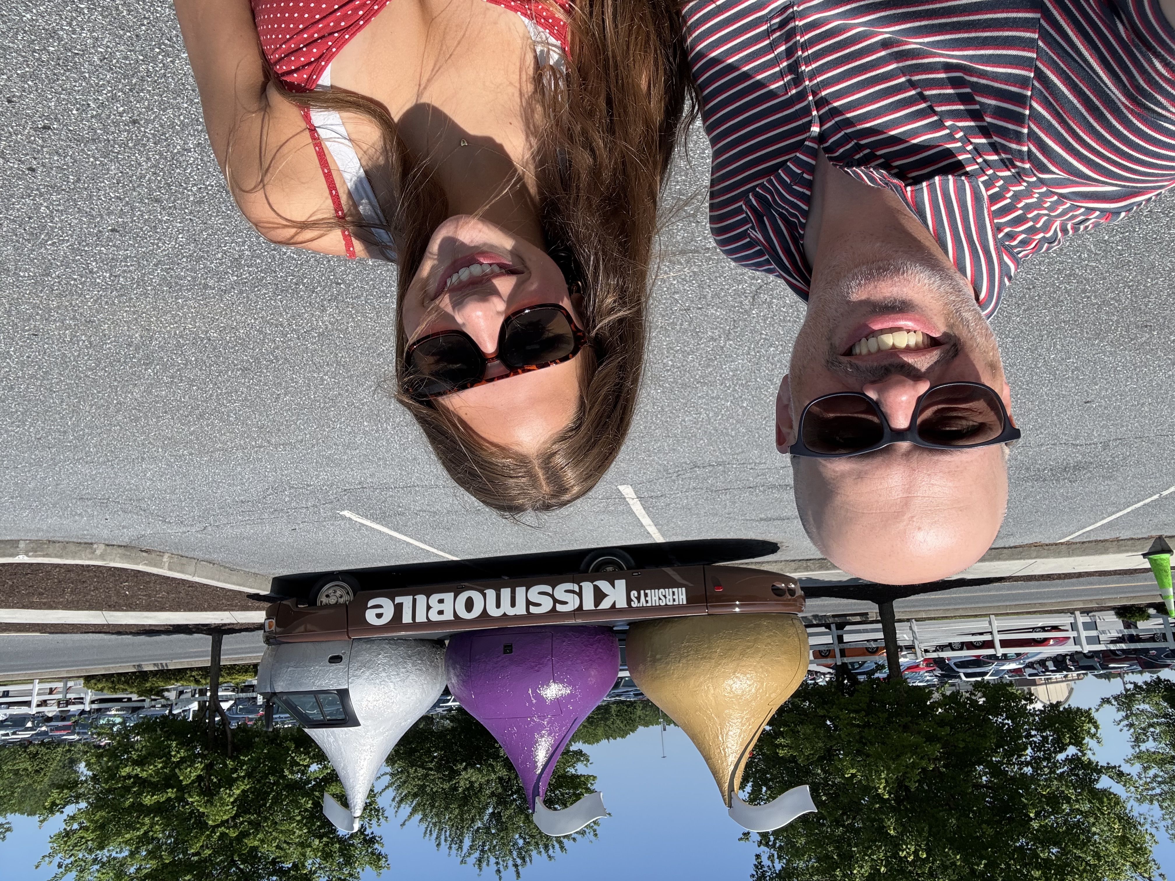 My daughter and I smiling in front of Hershey’s Kissmobile parked outside Chocolate World
